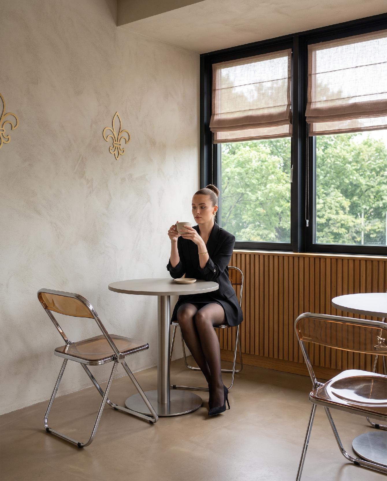 A photograph of a sleek, modern cafe interior with warm metallic accents and a bright, inviting atmosphere, ca