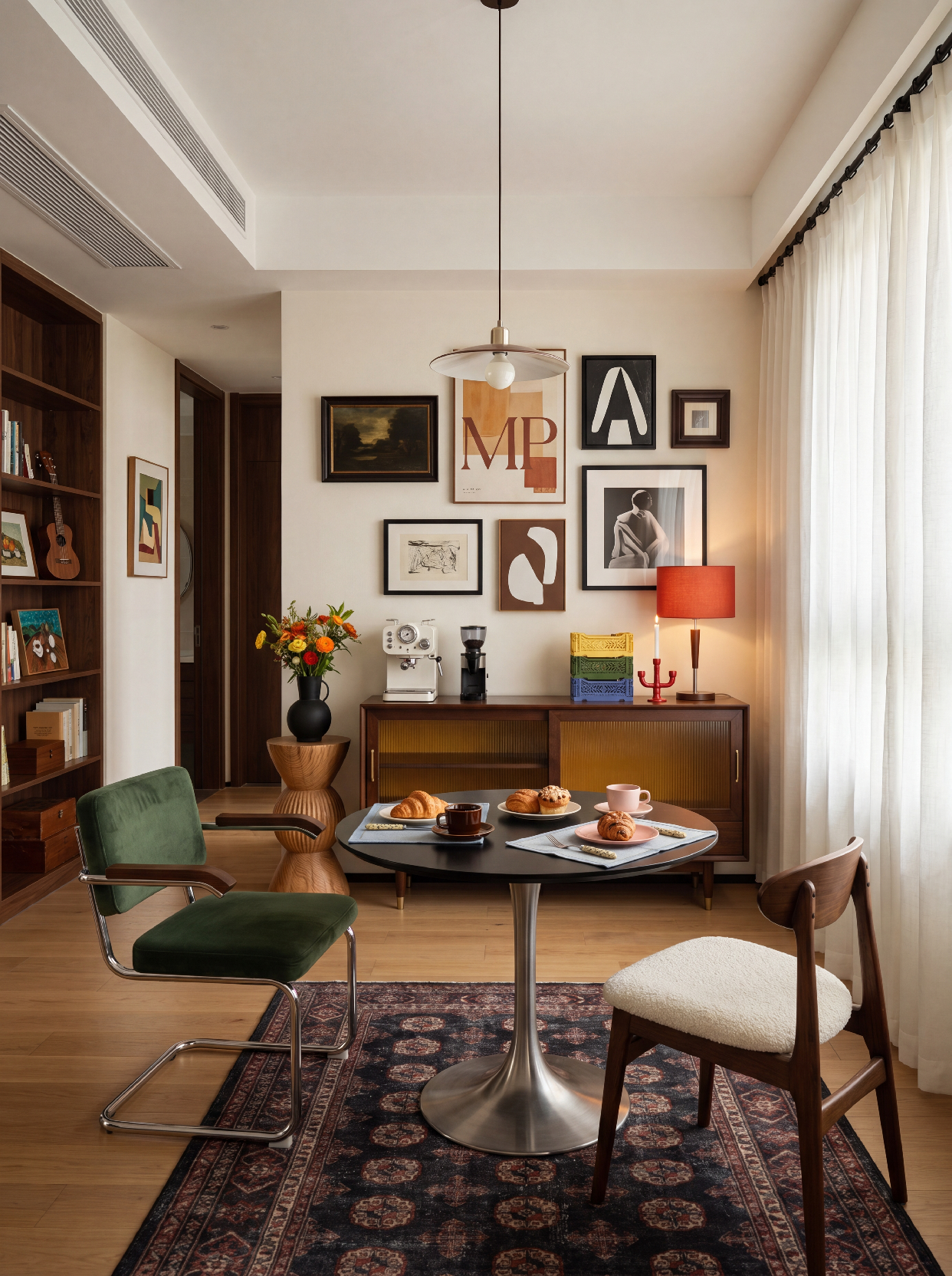 A photograph of a warm, curated mid-century modern dining nook with an eclectic art collection, captured at ey